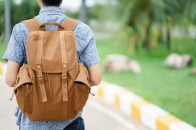 close-up-young-traveler-man-carrying-backpack-for-trip-concept_42708-102
